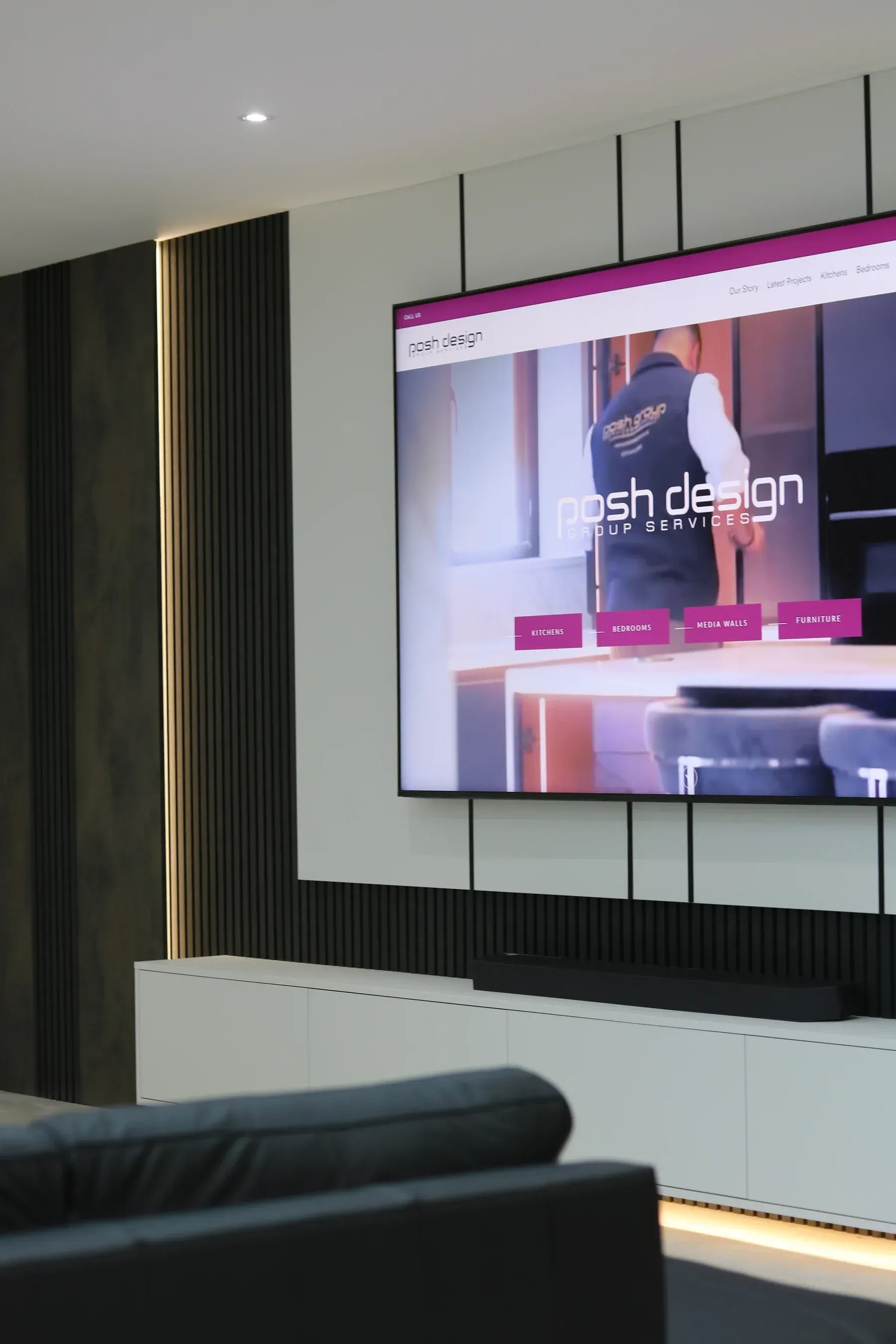 Dark fluted bespoke media wall with recessed television, real installation
