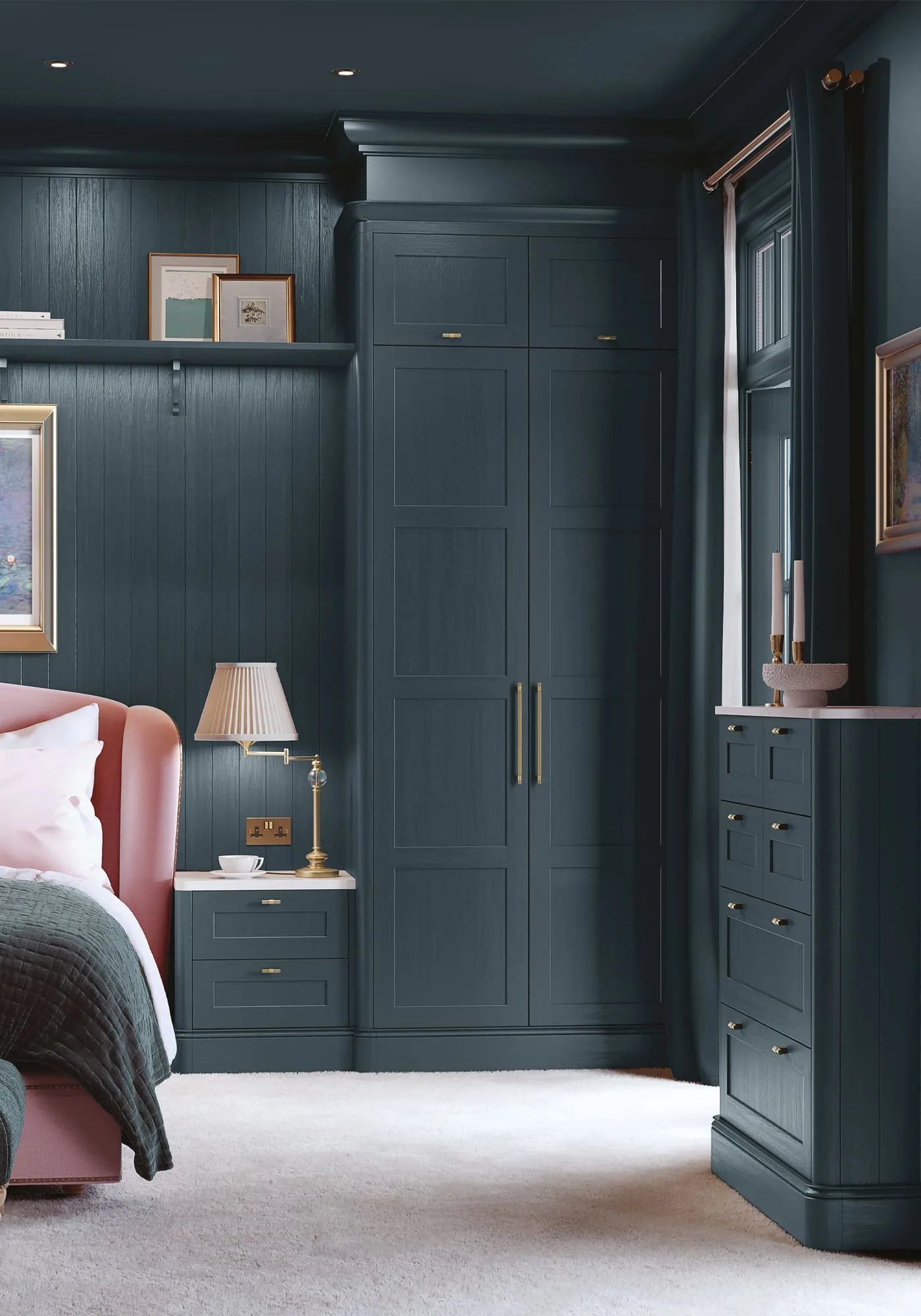 Navy bespoke fitted wardrobes in a panelled bedroom with pink armchair