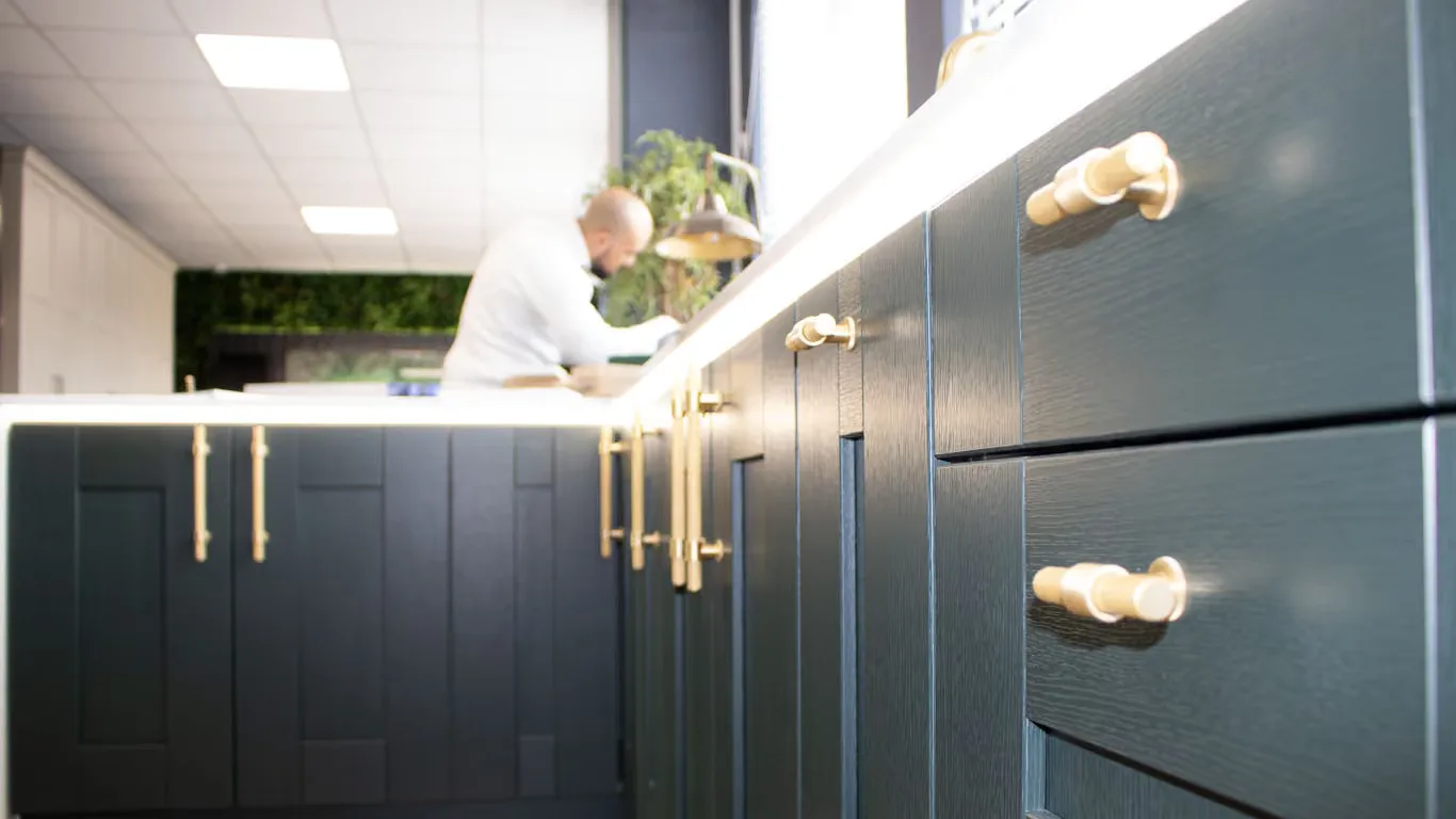 Navy shaker doors and brass handles on the bench in the Bespoke Bedrooms workshop